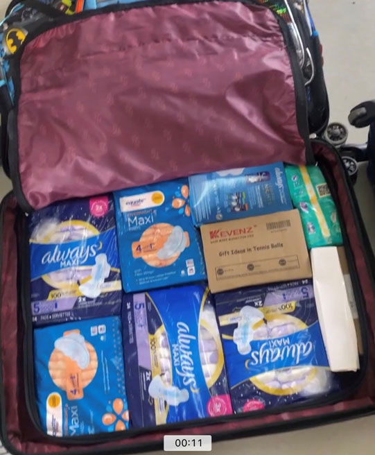 A suitcase full of feminine sanitary supplies.